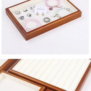 Close-up of wood jewelry tray with velvet lining showing detailed textures and dividers