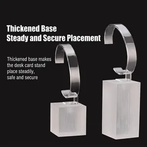 Clear acrylic watch display stands with frosted bases on black background set