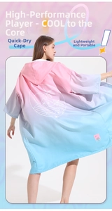 Macro view of quick-drying hooded surf poncho with pink and blue gradient design