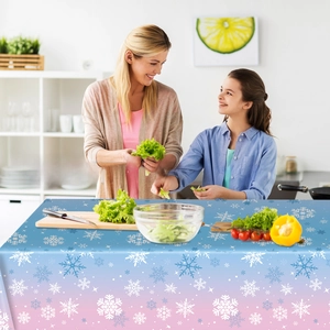 Blue and pink gradient snowflake tablecloth with soft drape in a cozy kitchen setting