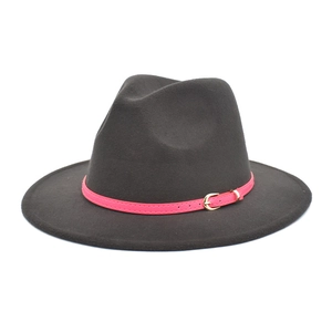 Detail of dark grey wool fedora hat featuring a bright pink belt and golden metal buckle