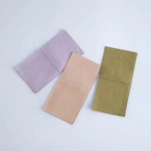 Flat lay view of microfiber jewelry pouches in soft purple, pink and olive green tones