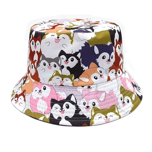 Detailed close-up of colorful cartoon dog prints on a canvas bucket sun hat