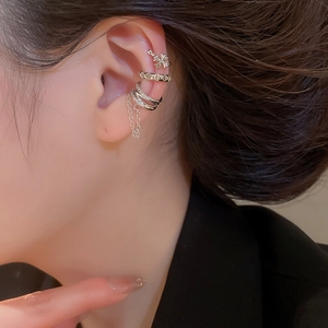 Detail view of silver heart ear cuffs with sparkling zircon stones and tassel chains