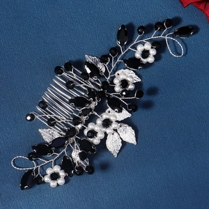 Detailed view of handcrafted silver wire bridal hair comb with pearls and black beads