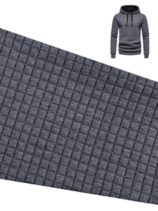Detail shot of men's grey hoodie featuring waffle knit texture and premium fabric finish