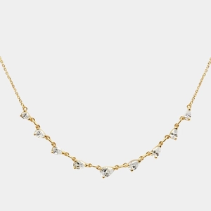 Macro shot of gold necklace featuring nine pear-cut zircons in a graceful curved layout