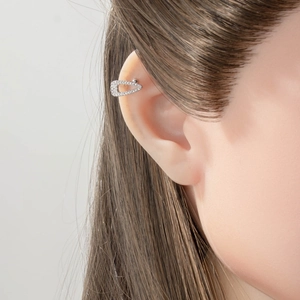 U-shaped silver ear cuff with micro-paved zircons on model ear for non-pierced styles