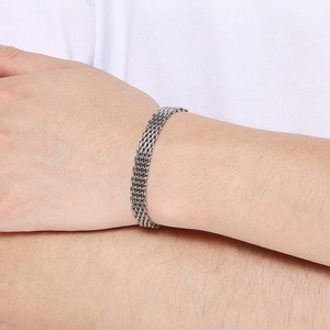 Close-up of multi-strand silver titanium steel woven bracelet on a male wrist