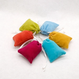 Colorful velvet drawstring jewelry pouches in six vibrant shades on white background