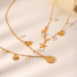 Golden stainless steel ocean theme necklace with pearls, starfish and seashell charms