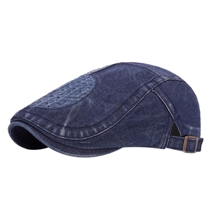 Washed dark blue denim flat cap with vintage distressed texture and adjustable metal buckle