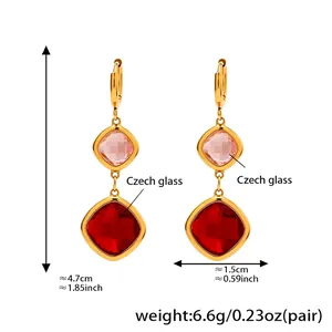 Detailed view of gold stainless steel earrings with pink and red Czech glass pendants