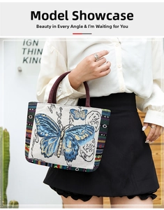 Artistic tote bag detail showing butterfly pattern and rainbow stripes with purple handles