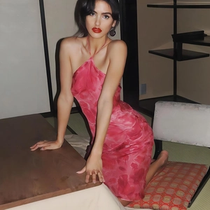 Pink halter neck floral print satin midi dress shown in a soft professional setting