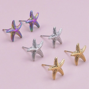 Macro detail of starfish earrings in gold, silver, and rainbow stainless steel finishes