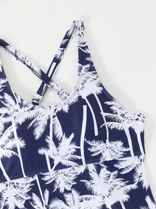 Detail of tropical palm tree print tankini top with adjustable crisscross back straps