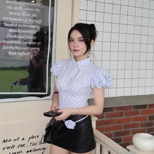 Women's blue striped puff sleeve polo top with a black mini skirt and floral belt set