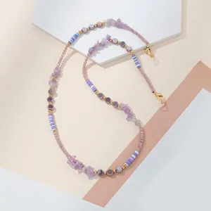 Detailed view of the handcrafted purple crystal and clay bead eyeglass chain with lobster clasps