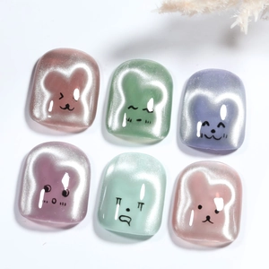 Detailed view of colorful cat-eye resin nail charms with cute animal face designs