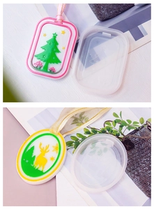 Detail of Christmas tree and reindeer silicone molds with finished DIY wax hanging tags