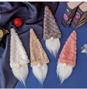 Close-up of assorted plush Christmas gnomes with knit hats and long faux fur beards