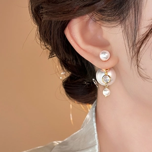 Elegant pearl earrings with zircon drop tassels and gold finish on a female model