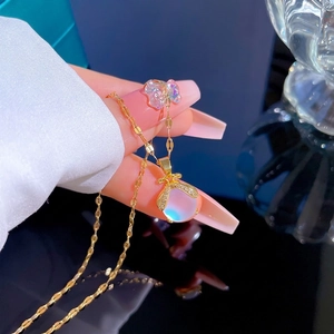 Gold-plated titanium necklace with aurora bead pendant and butterfly charm detail