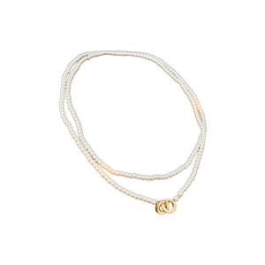Double-layered white pearl necklace with interlocking gold circular pendants
