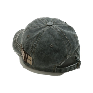 Detail of washed cotton baseball cap featuring side NY patch and vintage distressed brim