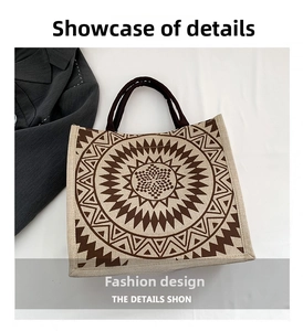 Detail of linen tote bag featuring brown geometric totem pattern and woven handles