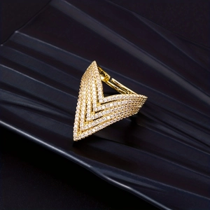 Macro shot of V-shaped gold ring featuring detailed pave-set white zircon stones