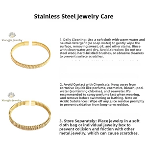 Detail of gold titanium steel bangle set featuring vertical ridges and twisted braid texture