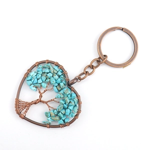 Macro shot of bronze wire-wrapped tree of life heart keychain with turquoise stones