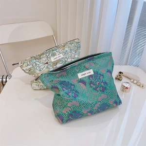 Detailed close-up of jacquard floral canvas makeup bags with elegant zipper and fabric label