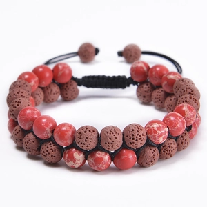 Close-up of double-layer braided bracelet with red marble beads and volcanic lava stones