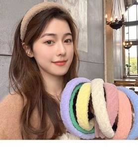 Selection of plush floral and textured headbands in multiple colors worn by a model
