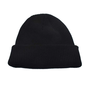 Detailed close-up of black ribbed knit wool blend beanie showing texture and elastic weave