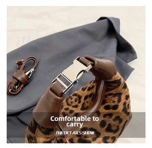 Detail of silver metal buckle on leopard print bag with brown faux fur texture