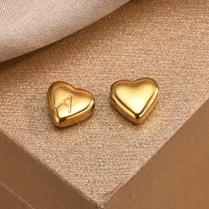 Golden heart-shaped stainless steel DIY bead with letter A engraving on textured surface