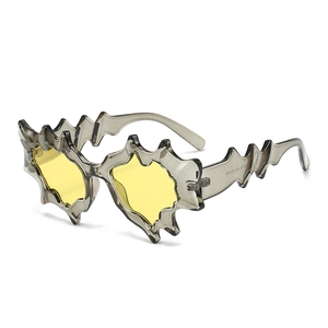 Modern irregular wave sunglasses with gray translucent frames and yellow lenses