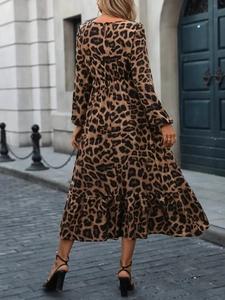 Detail of elegant leopard print maxi dress with lantern sleeves and ruffled A-line hem