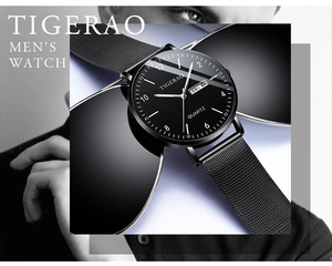 Detail of minimalist black quartz watch dial with dual calendar display and mesh band