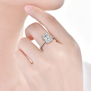 Macro shot of an emerald-cut high carbon diamond ring on hand with s925 silver pave band