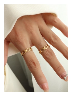 Close-up of gold chain hollow rings with adjustable design on hand for a chic look