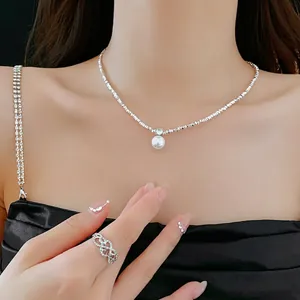Elegant silver bead necklace with round pearl pendant worn on collarbone