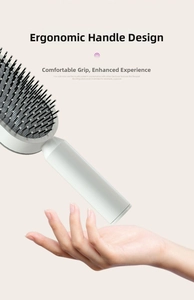 Ergonomic long handle design of white cushion hairbrush for comfortable daily grip