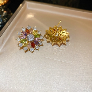 Detail of colorful sunflower earrings with zircon stones and gold-plated silver pin