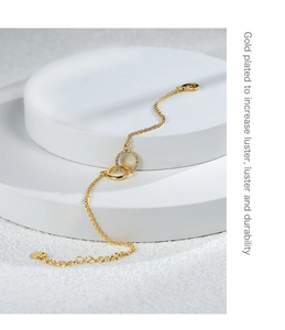Detail of gold-plated double ring bracelet with sparkling pavé cubic zirconia