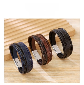 Close-up of three multilayer braided leather bracelets with silver magnetic alloy clasps